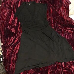 Easy wear short sleeves black dress with ruffled neckline and ruched waist .